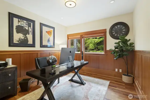This main floor office with custom wood paneling is ready for the at-home executive.