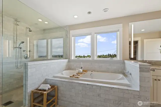 Heated floors, a frameless glass walk-in shower, dual vanities, and a soaking tub with incredible views - this is luxury.