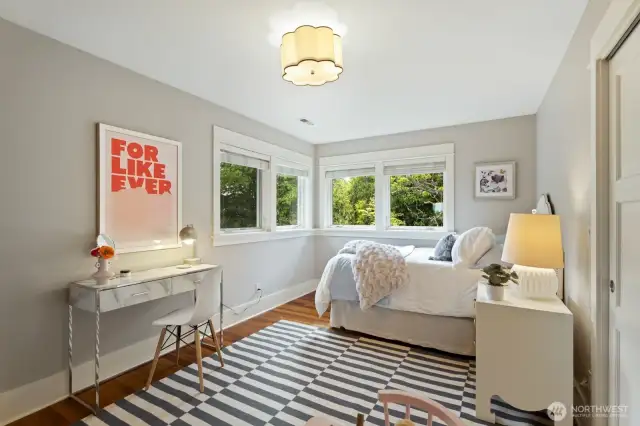 Second upstairs bedroom takes in beautiful treed views of the backyard.