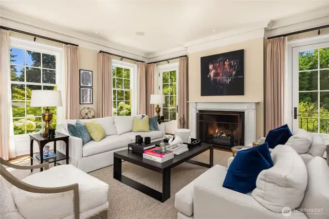 To the left of the entry hall is the formal living room.  Wood burning fireplace, a perfectly scaled room with big windows on 2 sides which flood the room with sunshine.