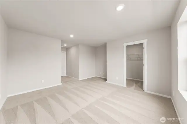 Spacious and private, the primary suite includes plush carpet, natural light, and a large walk-in closet.  Pictures are for representational purposes only, colors and features may vary.