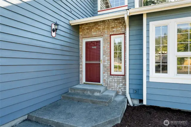 Brick framed front door invites you in to your beautiful new home.