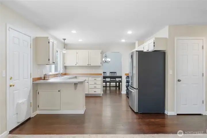 All appliances stay with the home. Pantry is the first door to the right of the refrigerator, and the garage door is at the end of the hallway.