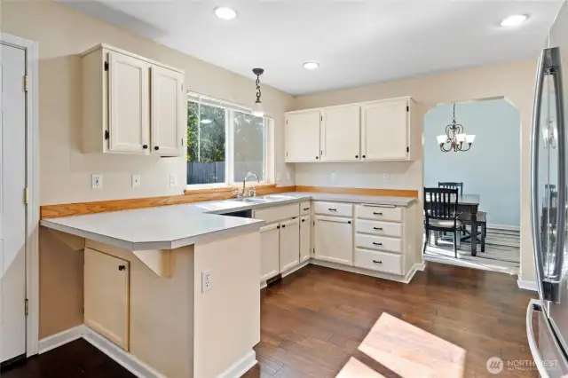 Open kitchen is perfect size for multiple cooks and bar seating adds extra space for guests to join in the party.