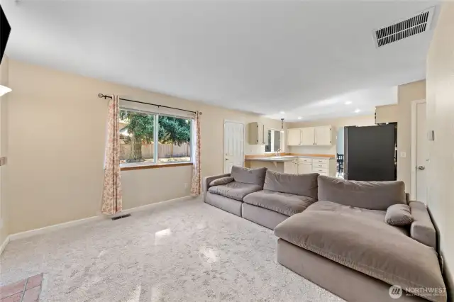This room is much larger than it appears and has plenty of room for all your furniture. Door on the left leads outside to your backyard.