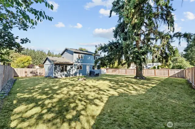 Fully fenced back yard is spacious enough for multiple uses and ready for your imagination.
