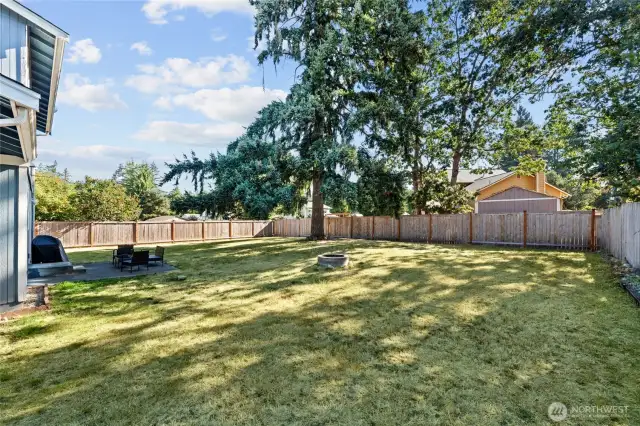Concrete patio is the perfect spot for outdoor grilling and this space offers endless memories around the firepit.