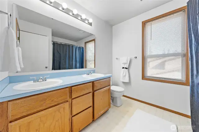 Dual sink makes getting ready in the morning stress free. Large linen closet located just behind the doorway adds additional function to this room.