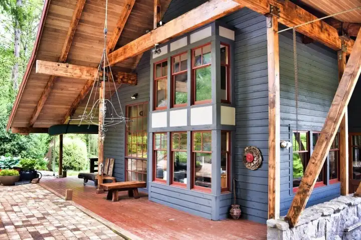 Featuring beautiful raw timber, cobblestone patio and custom stone accent wall.