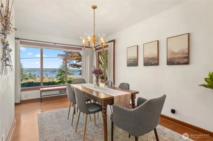 A wall of elegant wood-trimmed windows fills the living and dining rooms with natural light, framing the harbor views.