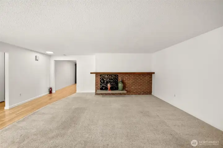 Large, bright living room with wood fireplace.