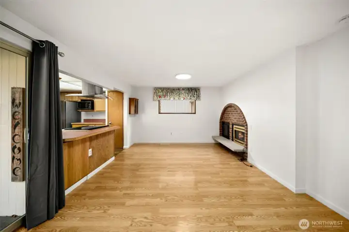 Dining area looking towards the kitchen to the left and the family room area (straight ahead). Family room has gas fireplace.