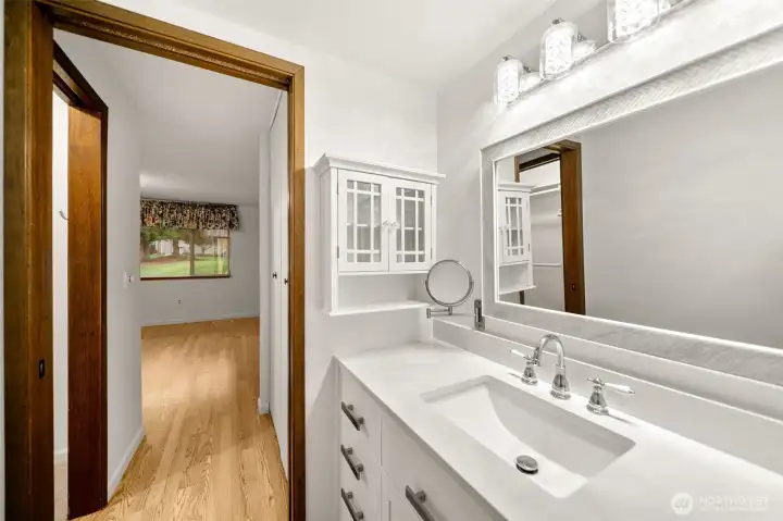 Primary bathroom, looking back towards primary bedroom.