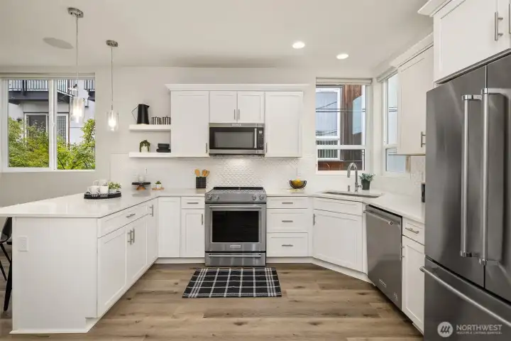 Light and bright kitchen with sleek cabinetry, white quartz countertops and all KitchenAid appliances.