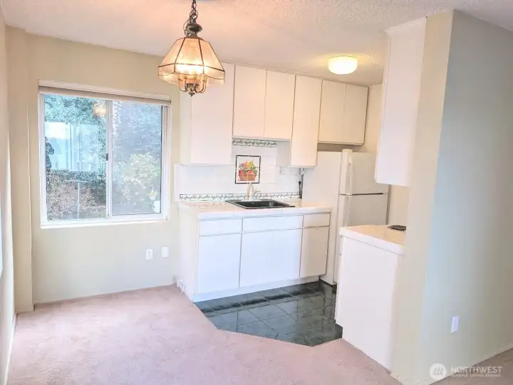 Quaint kitchen & dining area look to the greenbelt on one side, Puget Sound views on the other side.