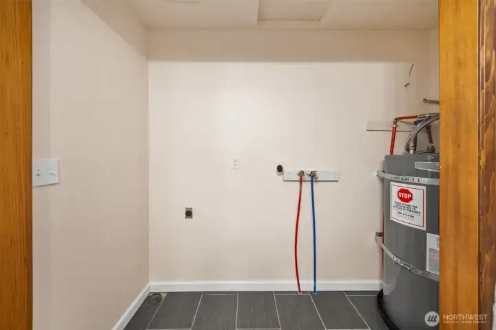 Washer/dryer hook up and water heater located in bathroom.
