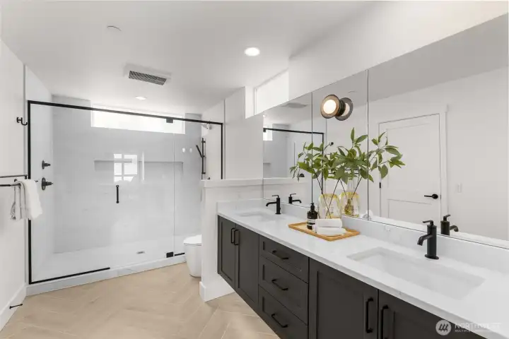 Spa-like walk-in shower with sleek glass enclosure and premium hardware.