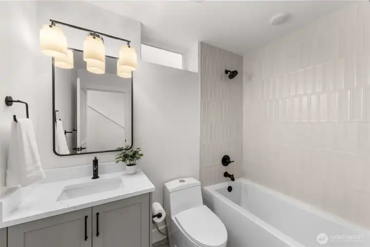 Secondary bathroom showcasing clean lines, a full tub, and contemporary finishes.