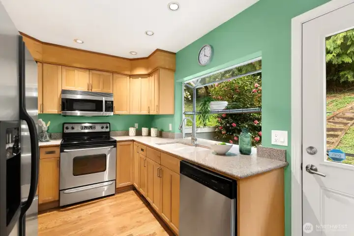 Big greenhouse window looks out on back patio