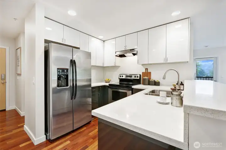 Cooking in this space is a true delight, equipped with stainless appliances, quartz counters & sleek cabinetry.