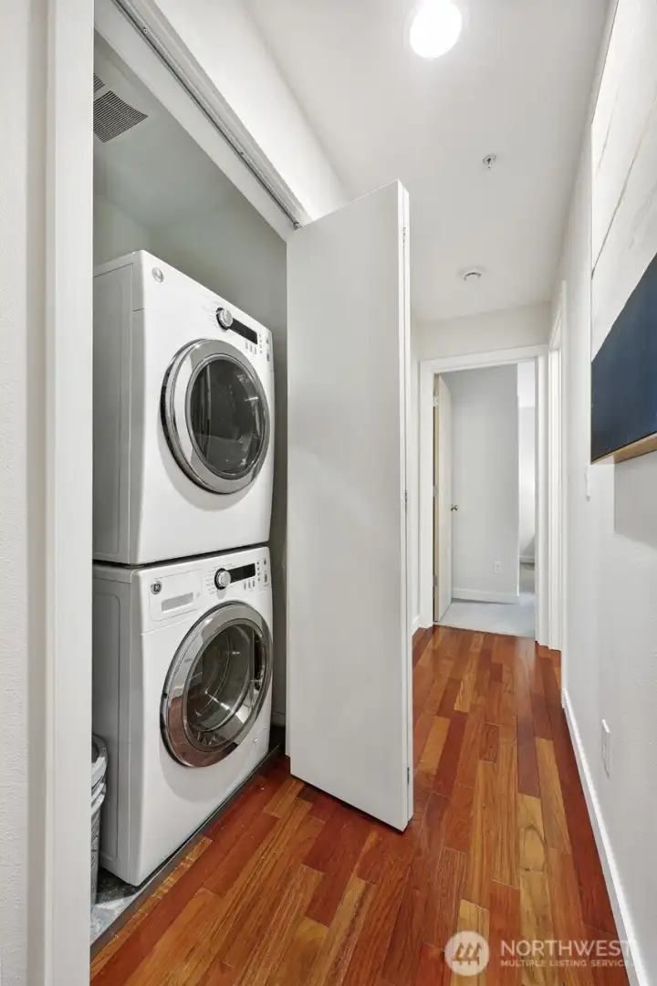 No need to save up your quarters - in-unit laundry handy in the hallway.