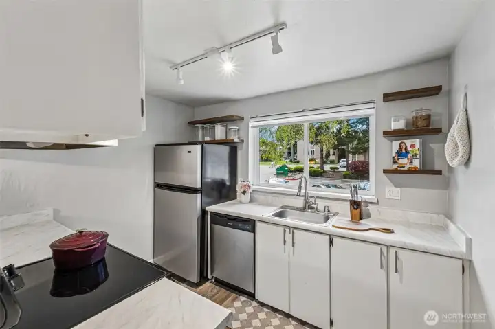 Stainless appliances and open wood shelving