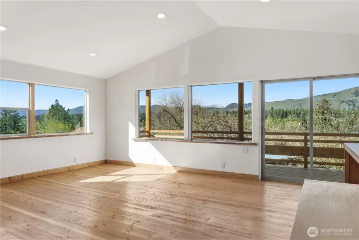 Open living room area with sliding door to the deck, off the kitchen
