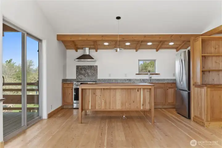 Custom kitchen cabinets and bar, stainless steal appliances.