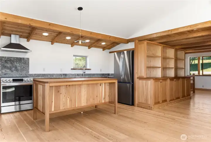 Custom kitchen cabinets and bar, stainless steal appliances.