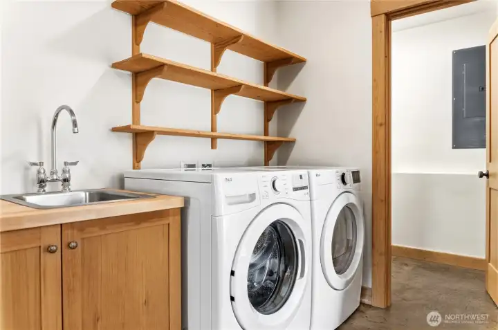 Laundry room with utility sink and custom cabinets