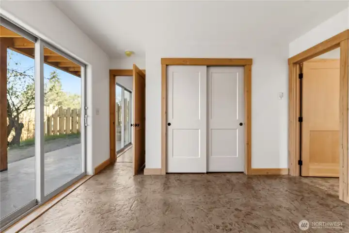 Primary bedroom with sliding doors to patio, closet and private 3/4 bath.