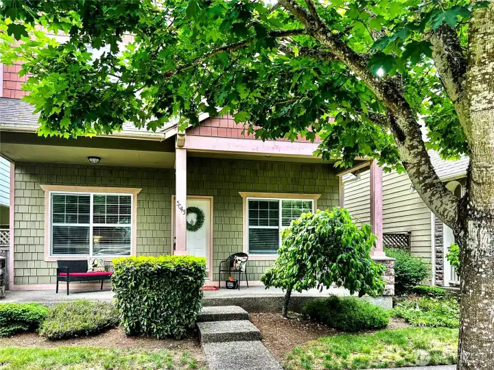 Inviting front porch is the perfect place to sit for a while and watch the walkers go by.