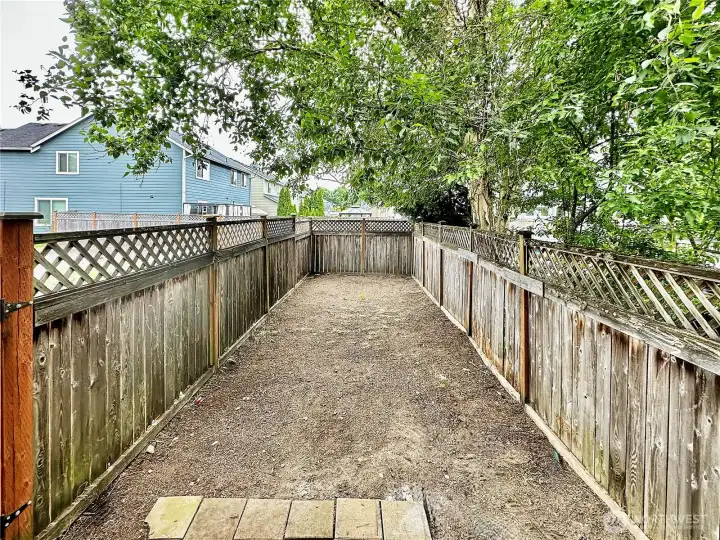 Back fenced area is waiting for you landscaping touches.
