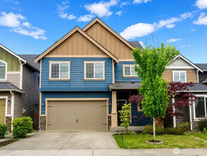 Beautiful curb appeal featuring stylish exterior finishes, thoughtful landscaping, and a welcoming covered entry.