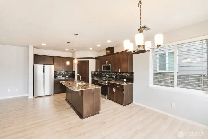 Beautiful kitchen featuring a large center island, stainless steel appliances, and abundant cabinetry.