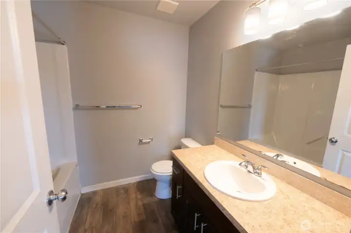 Full hall bathroom with a tub/shower combination and contemporary finishes.