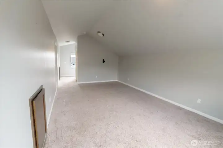 Spacious upper-level loft offering endless possibilities for work, relaxation, or entertainment.