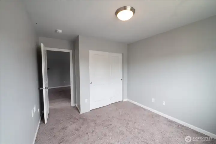 Comfortable third-floor bedroom conveniently located near the loft/bonus area.