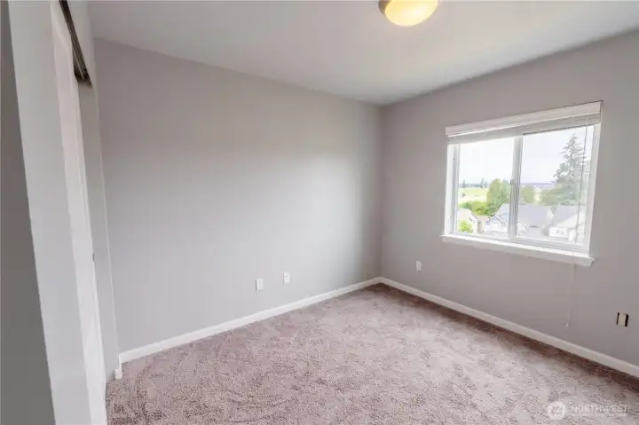 Versatile upper-level bedroom ideal for guests, multigenerational living, or a home office.