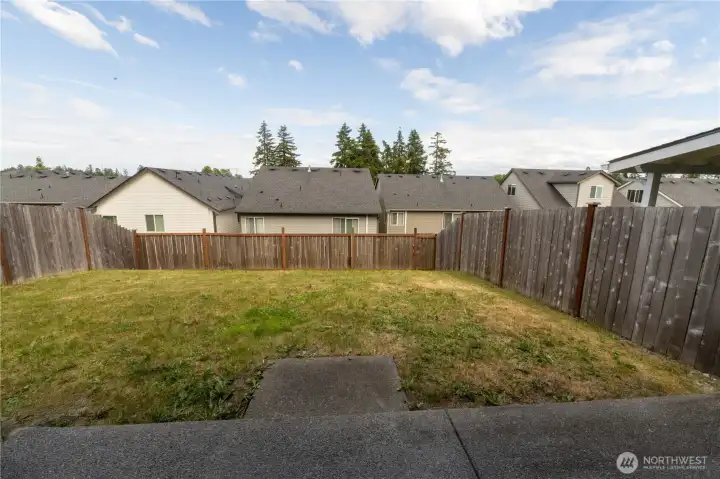 Fully fenced backyard offering space for outdoor entertaining, pets, and play.