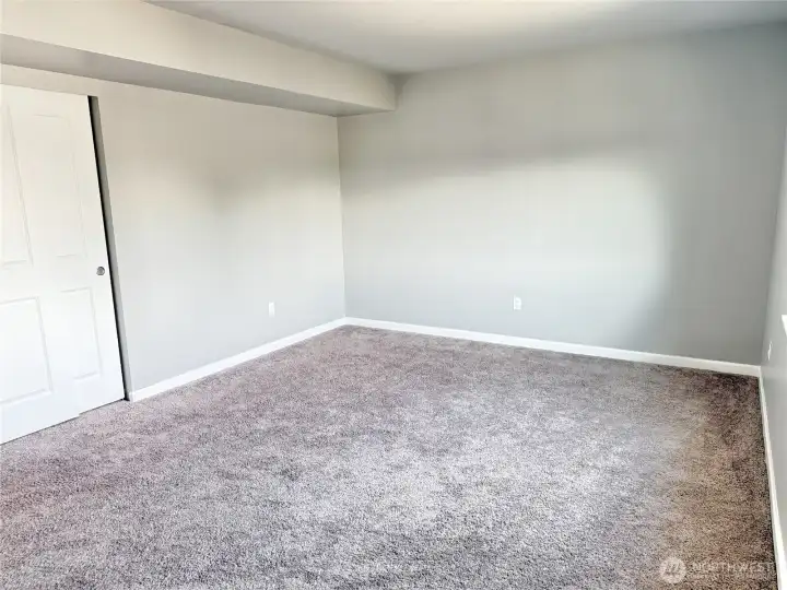 Spacious third bedroom offering a flexible layout, generous closet space, and abundant natural light.