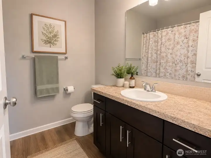 Second-floor full bathroom conveniently located across the hall from the secondary bedrooms, featuring a spacious vanity and tub/shower combination.