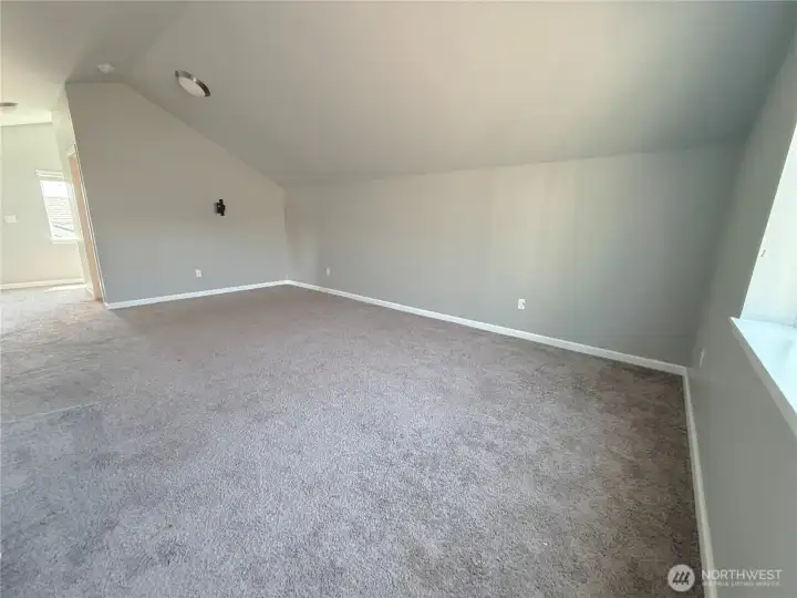 Spacious upper-level loft offering endless possibilities for work, relaxation, or entertainment.