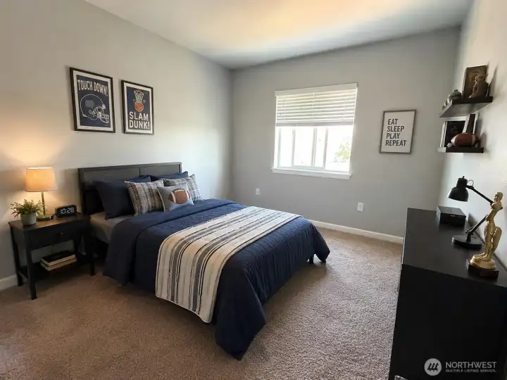 Virtually staged third-floor bedroom showcasing a spacious layout and flexible living space