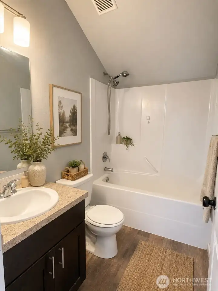 Convenient third-floor full bath featuring a spacious vanity and tub/shower combo