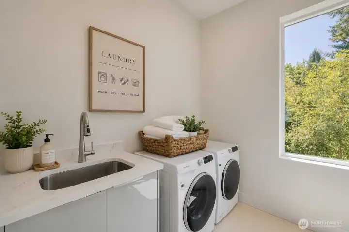 2nd floor laundry room sink, folding space, cabinets and big tree view 2nd floor laundry room sink, folding space, cabinets and big tree view