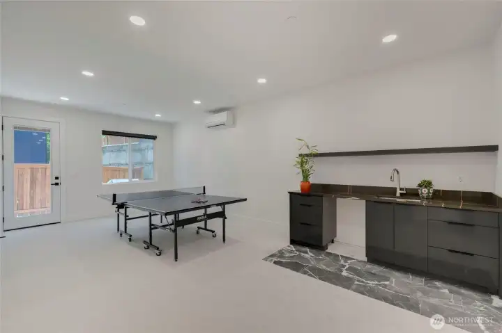 Lower level Game room space for pool, ping-pong, corn-hole. There is a full bath off game room and 5th guest room with outside access to back yard. NOTE: Fridge is ordered! Lower level Game room space for pool, ping-pong, corn-hole. There is a full bath off game room and 5th guest room with outside access to back yard. NOTE: Fridge is ordered!
