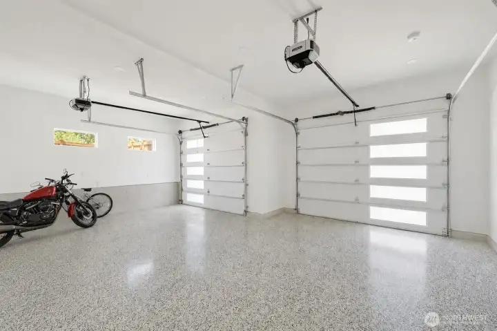 Spacious garage with coated floor and EV charger Spacious garage with coated floor and EV charger