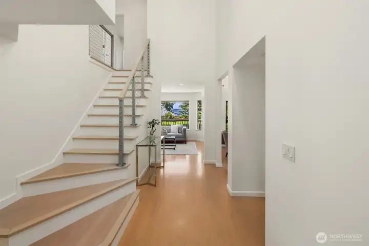 A dramatic two-story entry makes an unforgettable first impression, where modern lines, abundant natural light, and immediate views of Lake Washington set the tone for the home beyond.