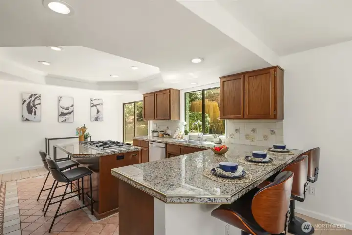 The kitchen is generous in size and in opportunity. Keep the current layout, or redesign from scratch to suit your needs.